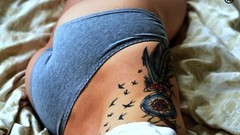 Woman beds tattoos panties