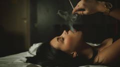 Woman beds watches earrings smoking closed eyes open mouth 