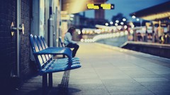 Woman bench pavement bokeh depth of field train stations