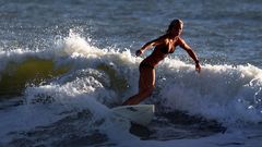 Woman bikini waves surfing