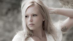 Woman blondes Brea Bennett hands on head white shirt upscaled