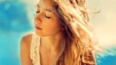 Woman blondes closed eyes blurred background