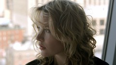 Woman blondes curly hair window panes