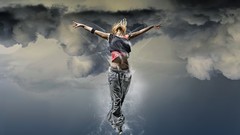 Woman blondes jumping artistic arms raised free spirit