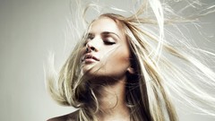Woman blondes models hair in face