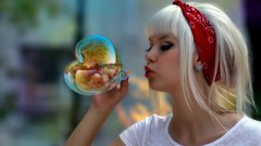 Woman blondes playing iridescence blowing bubbles