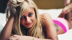 Woman blondes tattoos smiling lying down panties