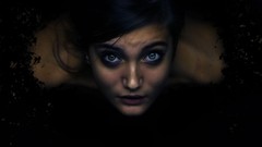 Woman blue eyes black hair looking up