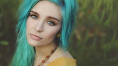 Woman blue hair yellow dress necklaces