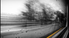 Woman blurred trains window panes