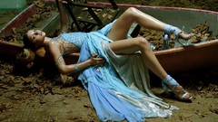 Woman Boats fashion models lying down blue dress fallen leaves 