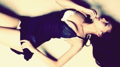 Woman brunettes black dress lying down pale skin