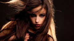 Woman brunettes models hair in face
