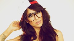 Woman cap close-up glasses white background faces brown eyes 