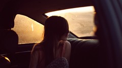 Woman cars brunettes hair in face