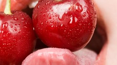 Woman cherries tongue fruits