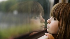 Woman children reflections window panes