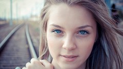Woman close-up faces blondes blue eyes railroad tracks