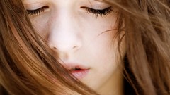 Woman close-up faces closed eyes