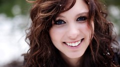 Woman close-up faces smiling blue eyes brunettes curly hair 