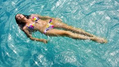 Woman closed eyes bikini swimming pools
