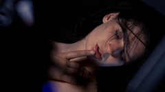Woman closed eyes models black hair open shirt fingers on lips 