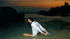 Woman coast wet shore