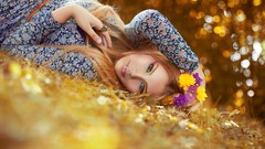 Woman colors lying down flower in hair redheads