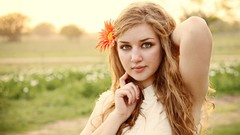 Woman faces blondes green eyes models flower in hair