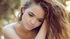 Woman faces blondes hands on head