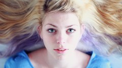 Woman faces blondes lying down