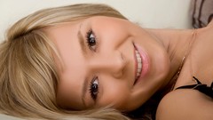 Woman faces blondes smiling brown eyes models bra lying down 
