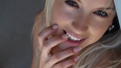 Woman faces blondes smiling models fingers on lips 