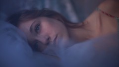 Woman faces blue eyes lying down
