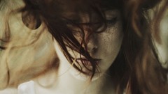 Woman faces freckles redheads hair in face