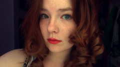 Woman faces green eyes redheads curly hair upscaled