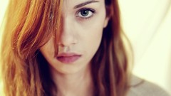 Woman faces green eyes redheads hair in face