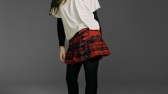 Woman faces looking down skirts long hair green eyes standing 