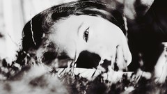 Woman faces monochrome lying down