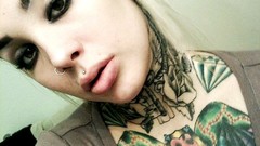 Woman faces tattoos ear plugs