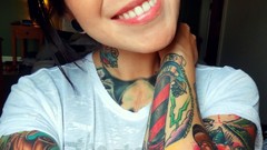 Woman faces tattoos piercings black hair