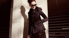 Woman fashion sunglasses hands in pockets hair up