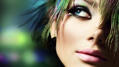 Woman feathers peacock colors faces blue eyes blurred 