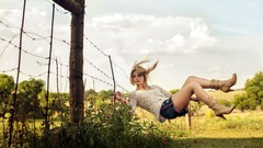 Woman fences legs blondes denim shorts leather boots barb wire 
