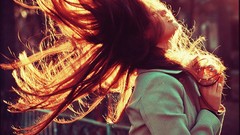 Woman fences sunlight long hair flipping hair back