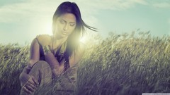 Woman fields backlit skies