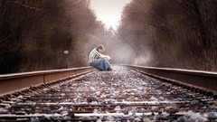 Woman forests railroad tracks