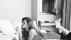 Woman Gisele Bundchen lying down grayscale striped clothing