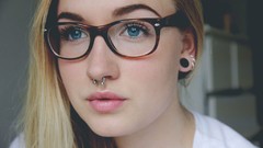 Woman glasses blondes blue eyes piercings