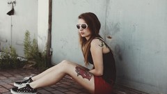 Woman glasses Shorts sitting sunglasses tattoos long hair 
